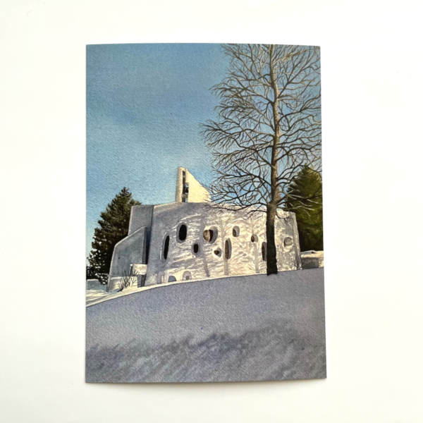A postcard image of a watercolour painting, showing the modernist church Temple Saint Jean in the snow and dappled with the shadow of a bare tree.